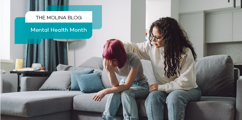 woman comforting other woman on couch