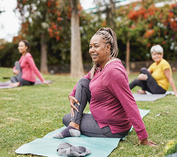 ladies doing yoga in the park