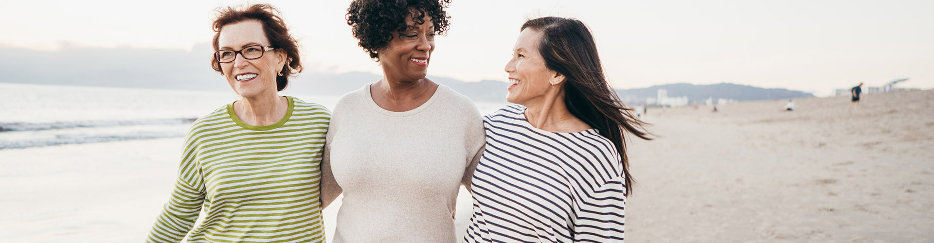 3 woman walking on the beach